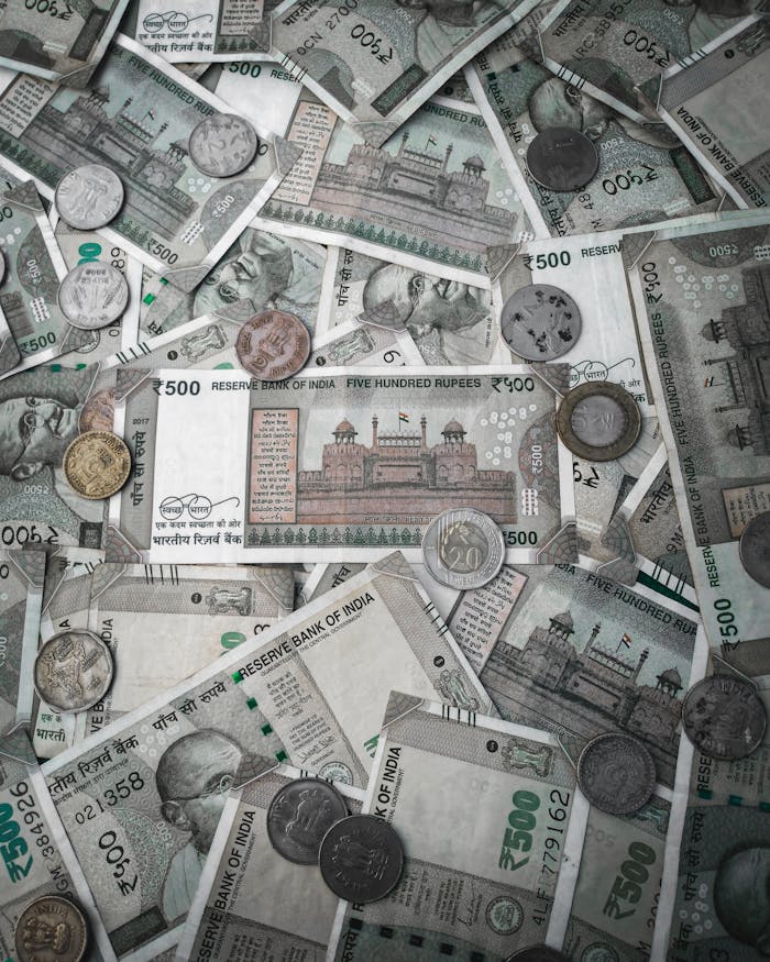 A detailed flat lay of various Indian rupee banknotes and coins, showcasing currency diversity.